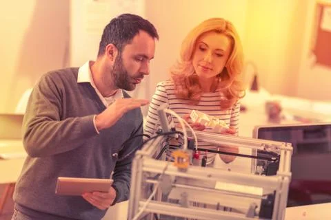 Knowledgeable boss giving his assistant helpful instructions. Stock Photos