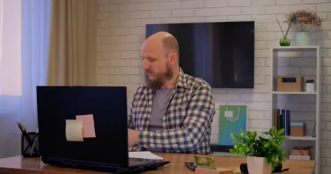 Knowledgeable man managing home-based business, knowledge reflected in strategic Stock Footage 301528050