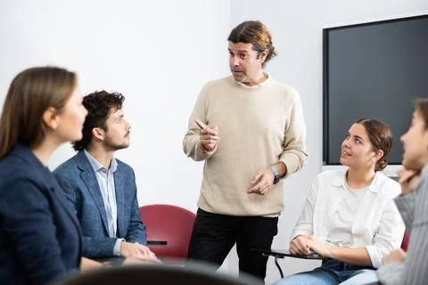 Knowledgeable professor explaining subject to classroom full of students Stock Photos