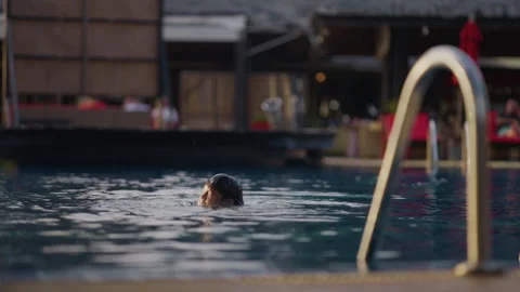 Koh Chang Resort Pool at Sunset with Child Playing in Water Stock Footage 337532548