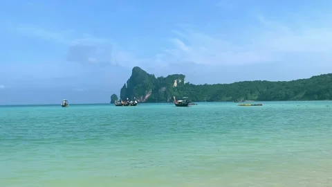 Koh phi phi bech in krabi, thailand. turquoise water, boats in lagoon, jungle Stock Footage 155005839