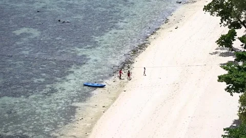 Koh Samui, Thailand - July 2, 2026: People walking along a tropical beach. Stock Footage 344787417