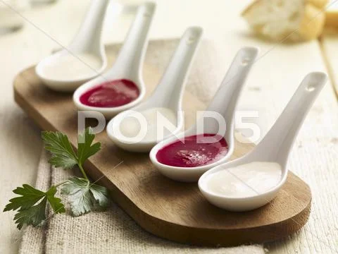 Kohlrabi and beetroot sauce on porcelain spoons Stock Photos