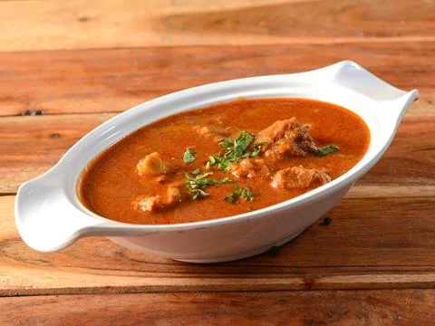 Kolhapuri Mutton masala or Kolhapuri Mutton tambda rassa or red meat curry is Stock Photos