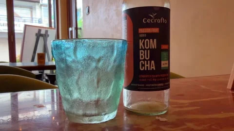 Kombucha Drink Glass and Bottle Cafe Table Healthy Fermented Tea Stock Footage 333862953