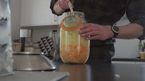 Kombucha, flavored fermented drink, Man preparing trendy drink in a Modern Stock Footage 203824731