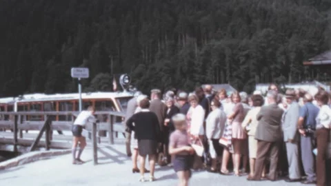 Königssee, Austria - 1972: Long queue of tourists waits for boat arrival Stock Footage 196289658