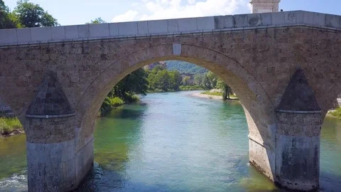 Konjic river bridge passing under aerial Stock Footage 102847574