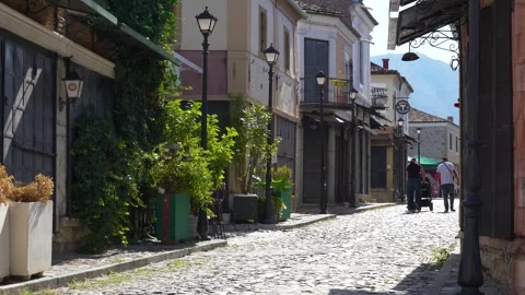 Korça old bazaar alleyways with cobblestone streets artisan shops and local Stock Footage 344907241