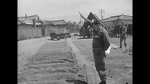 KOREA - 1950 - US chaplain prays over graves of American soldiers in Daegu Stock Footage 284652724