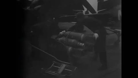 KOREA - 1951 - Men retrieve bombs from an elevator on flight deck. Crewmen Stock Footage 312792871