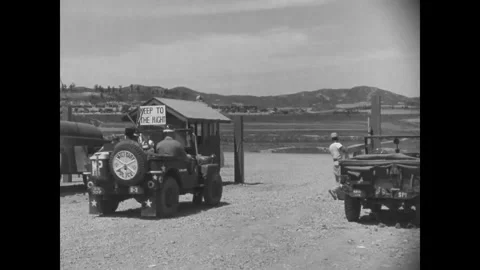 KOREA - 1952 - A US Army MP truck convoy drives through a supply point in Korea. Stock Footage 340665802