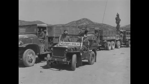 KOREA - 1952 - A US Army MP truck convoy arrives at a supply point in Korea. Stock Footage 340665804