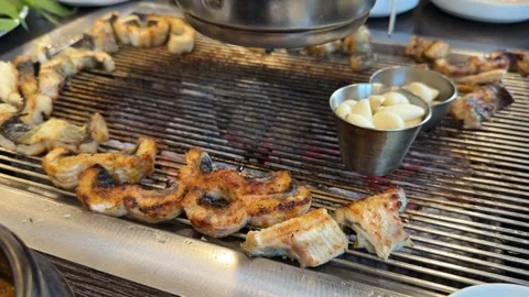 Korean BBQ Eel Slices Smoking on Charcoal Grill Stock Footage 337548414