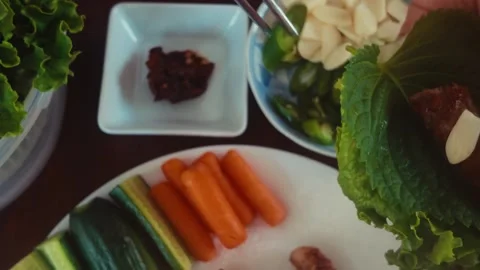 Korean BBQ Lettuce Wrap with Pork Belly Garlic and Ssamjang 4K Stock Footage 334869637