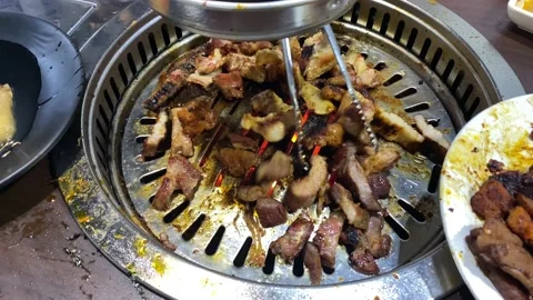 Korean BBQ meat grilling in the tabletop pan Stock Footage 125193655