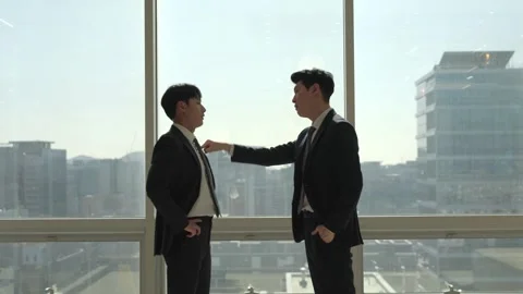 Korean Businessman Pointing While Explaining to Colleague Stock-Footage 338048081