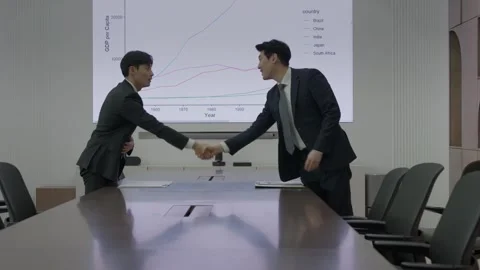 Korean Businessman Presenting Documents to Team at Table 스톡 동영상 338144057
