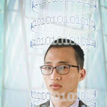 Korean businessman surrounded by circles of binary code Stock Photos