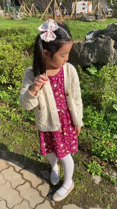 Korean child exploring plants; Vertical Stock Footage 317433205