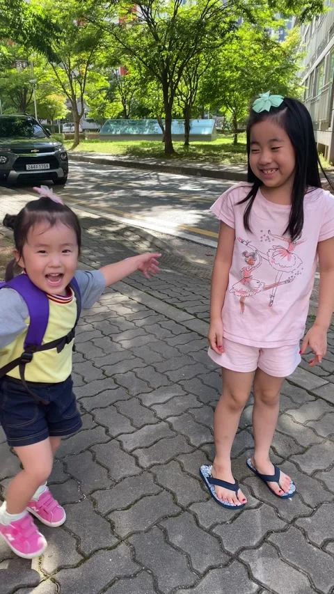 Korean children play at apartment complex; Vertical; 4K Stock Footage 317433154