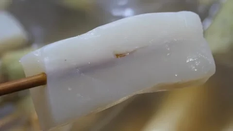 Korean Fish Cake Eomuk Skewer in Savory Broth Close-up Stock Footage 337374331