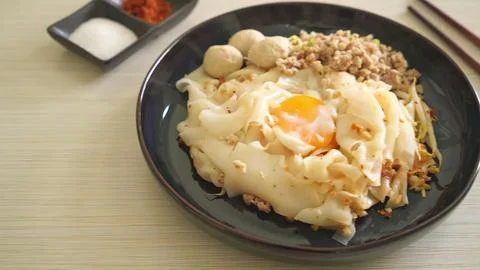 Korean fried chicken with fried egg and rice on black plate Stock Photos
