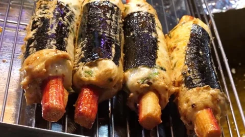 Korean Fried Fish Cake Rolls with Seaweed Wrapped on Metal Rack Stock Footage 337374515