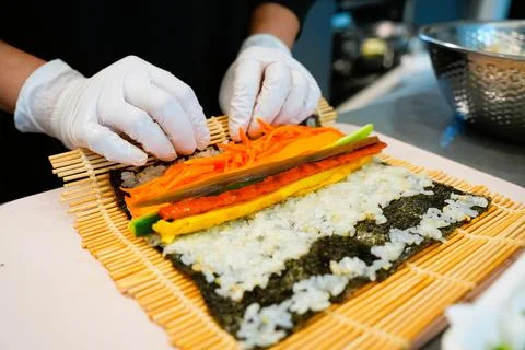 Korean Kimbap: The Culinary Process of Rolling and Slicing Gimbap Stock Photos