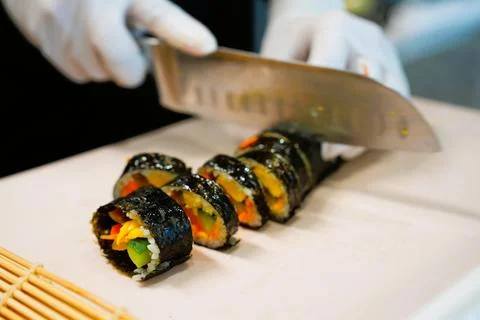 Korean Kimbap: The Culinary Process of Rolling and Slicing Gimbap Stock Photos