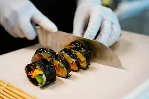 Korean Kimbap: The Culinary Process of Rolling and Slicing Gimbap Stock Photos