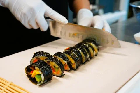 Korean Kimbap: The Culinary Process of Rolling and Slicing Gimbap Stock Photos