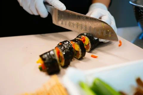 Korean Kimbap: The Culinary Process of Rolling and Slicing Gimbap Stock Photos