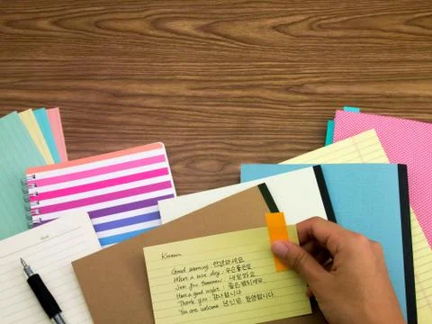 Korean; Learning New Language Writing Words on the Notebook Stock Photos