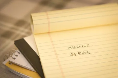 Korean; Learning New Language Writing Greetings on the Notebook Stock Photos