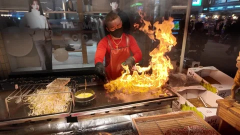 Korean Man Cooking Steak Night Market Myeong-Dong Seoul South Korea Video stock 296570153