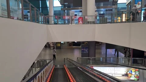 A korean man with mask going up the elevator inside the modern airport Stockbeeldmateriaal 246430623