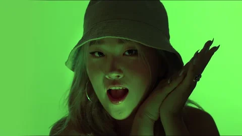 Korean model in studio with colored green light and water reflection making Video stock 136659332