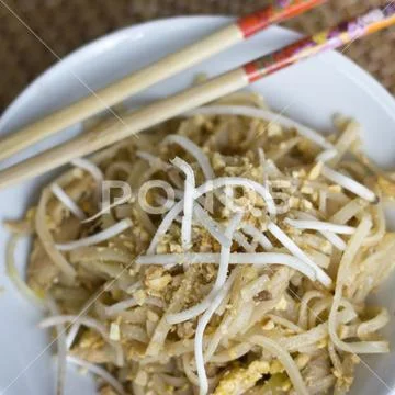 Korean rice noodles with soybean sprouts and crushed peanuts in a white bowl Stock Photos