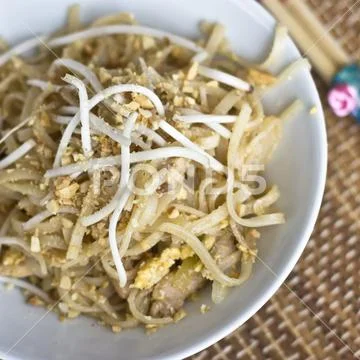 Korean rice noodles with soybean sprouts and crushed peanuts in a white bowl Stock Photos