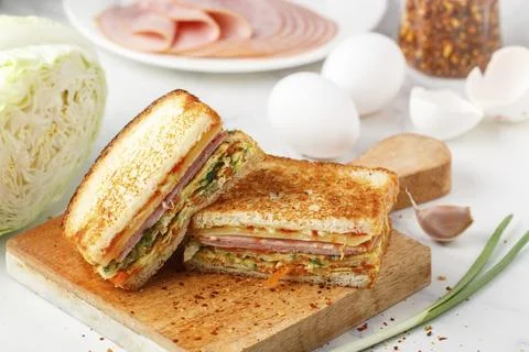 Korean sandwich of bread, eggs, cabbage, onions, carrots, with ketchup, Stock Photos