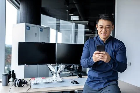 Korean worker programmer developer working inside modern office building with Photos