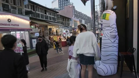 Koreans and foreigners walking around Hondae on Halloween during Covid-19 Stock Footage 164420144