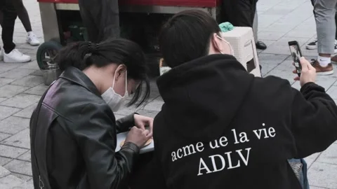 Koreans and foreigners walking around Hondae on Halloween during Covid-19 Stock Footage 164421171