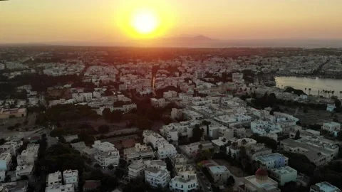Kos town during sunset with harbour, and island under sun in sea Stock Footage 138003763