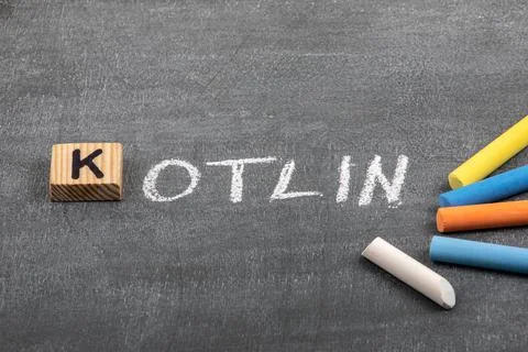 Kotlin code and programming language concept. Colored chalk pieces on a black Stock Photos