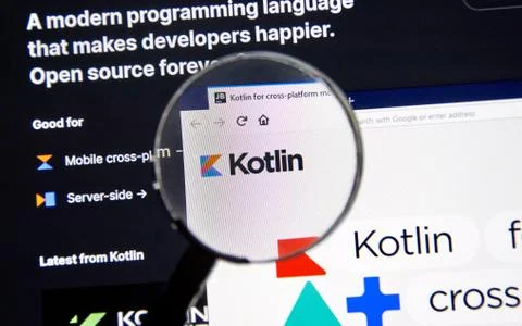 Kotlin example code, site and logo under magnifying glass Stock Photos