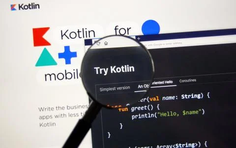 Kotlin example code, site and logo under magnifying glass Stock Photos