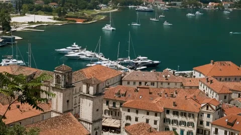 Kotor old town with orange rooftops and marina in Kotor bay with boats and 動画素材 267836015
