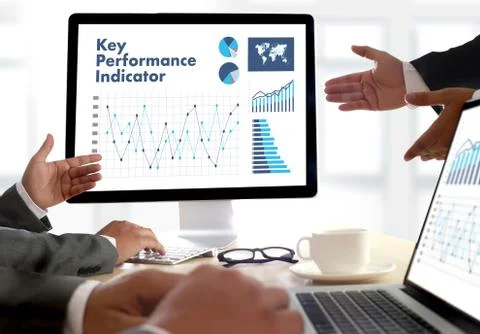 KPI acronym (Key Performance Indicator) Business team hands at work with fina Stock Photos